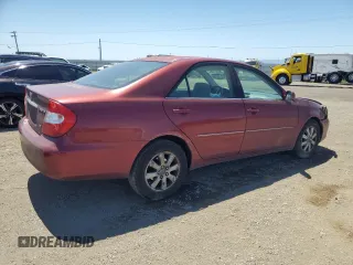 2003 Toyota Camry LE z VIN 4T1BF30K23U056007, wystawiony jako Copart lot #55187435 z przebiegiem 233 976 mil mil oraz Czysty tytuł • Clean title. Historia ofert i sprzedaży dostępna na DreamBid. Obrazek 3.