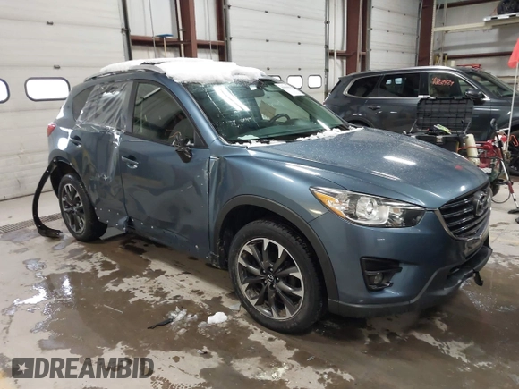 2016 Mazda CX-5 Grand Touring z VIN JM3KE4DY9G0714468, wystawiony jako IAAI lot #41860956 z przebiegiem 114 481 mil mil oraz . Historia ofert i sprzedaży dostępna na DreamBid. Obrazek 1.