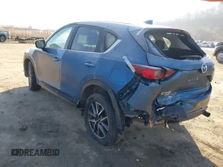 2018 Mazda CX-5 Touring z VIN JM3KFBCM2J0461954, wystawiony jako IAAI lot #41655865 z przebiegiem 129 333 mil mil oraz . Historia ofert i sprzedaży dostępna na DreamBid. Obrazek 3.