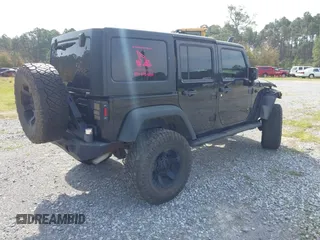 2012 Jeep Wrangler Unlimited Sport with VIN 1C4BJWDG2CL258264, listed as a IAAI auction lot 41880235 with 173,661 mi miles. Bid and sale history available at carsss.com. Image 4.