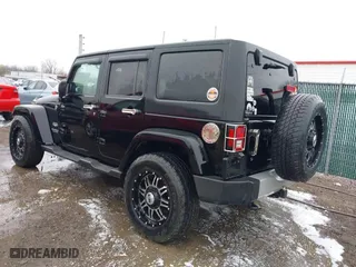2011 Jeep Wrangler Unlimited Sahara with VIN 1J4BA5H12BL548870, listed as a IAAI auction lot 42010303 with 139,693 mi miles. Bid and sale history available at carsss.com. Image 3.