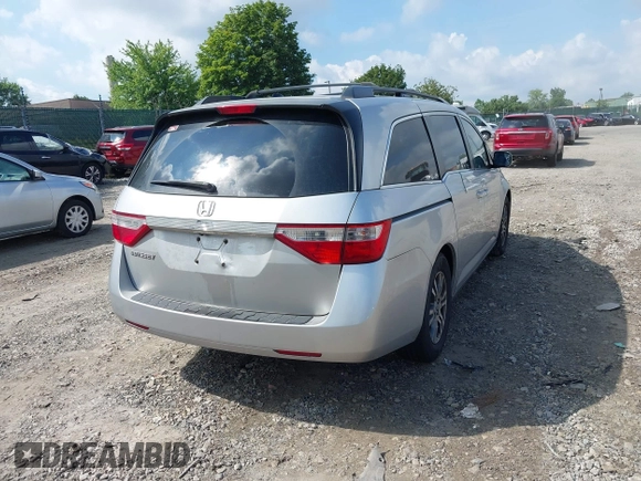 2012 Honda Odyssey EX-L with VIN 5FNRL5H61CB081634, listed as a IAAI auction lot 42760909 with 197,949 mi miles and . Bid and sale history available at DreamBid. Image 4.