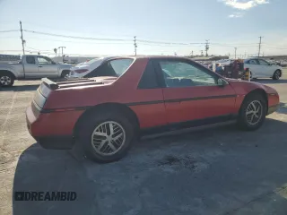 1986 Pontiac Fiero z VIN 1G2PF379XGP215474, wystawiony jako Copart lot #73346514 z przebiegiem 71 955 mil mil oraz Tytuł czysty. Historia ofert i sprzedaży dostępna na DreamBid. Obrazek 3.