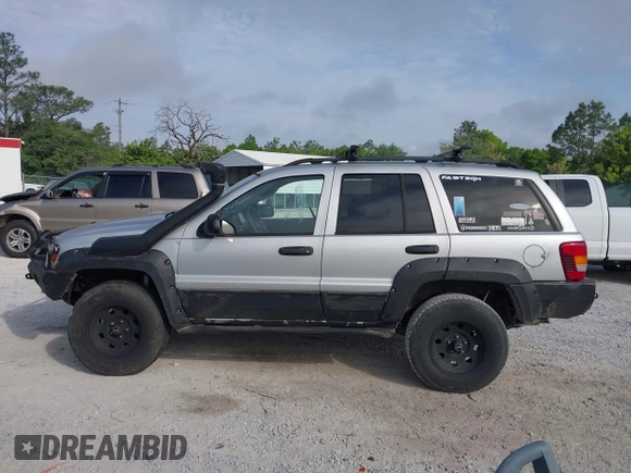 2003 Jeep Grand Cherokee Laredo z VIN 1J8GW48S33C519680, wystawiony jako IAAI lot #42126714 z przebiegiem 295 517 mil mil oraz . Historia ofert i sprzedaży dostępna na DreamBid. Obrazek 14.