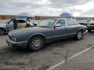1998 Jaguar XJ with VIN SAJHX1240WC832788, listed as a Copart auction lot 61876955 with 154,864 mi miles and Salvage title. Bid and sale history available at DreamBid. Image 1.