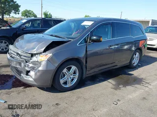2012 Honda Odyssey Touring with VIN 5FNRL5H95CB057346, listed as a IAAI auction lot 42644094 with 114,712 mi miles and . Bid and sale history available at DreamBid. Image 2.