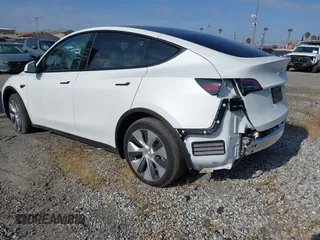 2024 Tesla Model Y with VIN 7SAYGDED2RF017448, listed as a IAAI auction lot 41597056 with 9,702 mi miles and . Bid and sale history available at DreamBid. Image 3.