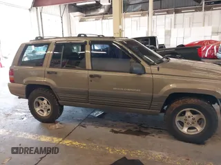 1996 Jeep Grand Cherokee Laredo with VIN 1J4GZ58S9TC293787, listed as a IAAI auction lot 41179368 with 141,755 mi miles. Bid and sale history available at carsss.com. Image 14.