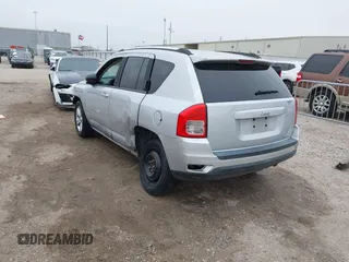 2011 Jeep Compass with VIN 1J4NT1FA7BD142600, listed as a IAAI auction lot 41590661 with 266,600 mi miles. Bid and sale history available at carsss.com. Image 3.
