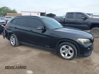 2014 BMW X1 sDrive28i with VIN WBAVM1C54EVW46561, listed as a IAAI auction lot 41880387 with 125,096 mi miles. Bid and sale history available at carsss.com. Image 1.