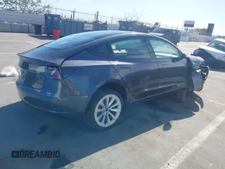 2022 Tesla Model 3 with VIN 5YJ3E1EA1NF142713, listed as a IAAI auction lot 42027630 with 112,557 mi miles. Bid and sale history available at carsss.com. Image 4.