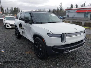 2025 Rivian R1S Adventure with VIN 7PDSGBBAXSN062963, listed as a IAAI auction lot 41598597 with 1,192 mi miles. Bid and sale history available at carsss.com. Image 1.