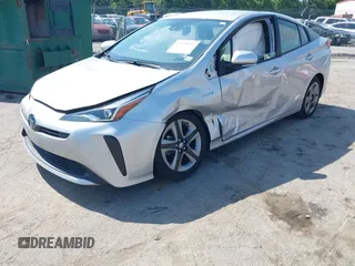 2021 Toyota Prius L Eco z VIN JTDKAMFU5M3137298, wystawiony jako IAAI lot #42270937 z przebiegiem 38 828 mil mil oraz . Historia ofert i sprzedaży dostępna na DreamBid. Obrazek 2.