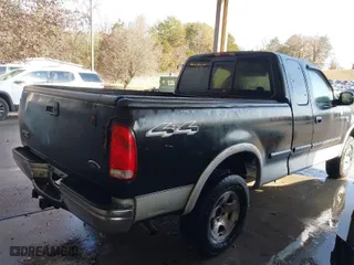 2000 Ford F-150 XL with VIN 1FTRX18LXYNA19385, listed as a IAAI auction lot 41075391 with 214,624 mi miles. Bid and sale history available at carsss.com. Image 4.