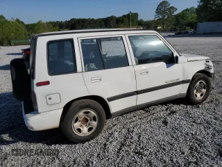 1997 Geo Tracker LSi z VIN 2CNBE1360V6927915, wystawiony jako Copart lot #53469605 z przebiegiem 119 413 mil mil oraz Szkody całkowita. Historia ofert i sprzedaży dostępna na DreamBid. Obrazek 3.
