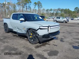 2024 Rivian R1T Adventure z VIN 7FCTGAAA5RN033799, wystawiony jako IAAI lot #41606562 z przebiegiem 9 449 mil mil oraz . Historia ofert i sprzedaży dostępna na DreamBid. Obrazek 1.