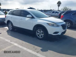 2015 Mazda CX-9 Sport with VIN JM3TB2BAXF0453244, listed as a IAAI auction lot 41905847 with 128,764 mi miles and . Bid and sale history available at carsss.com. Image 1.