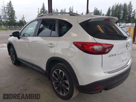 2016 Mazda CX-5 Grand Touring with VIN JM3KE2DYXG0675619, listed as a IAAI auction lot 42137144 with 106,262 mi miles and . Bid and sale history available at DreamBid. Image 3.