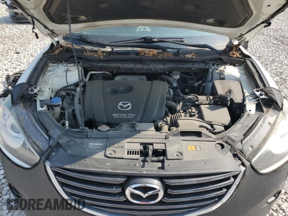 2016 Mazda CX-5 Grand Touring z VIN JM3KE4DY7G0864109, wystawiony jako Copart lot #59635865 z przebiegiem Nie podano mil oraz Czysty tytuł • Clean title. Historia ofert i sprzedaży dostępna na DreamBid. Obrazek 11.