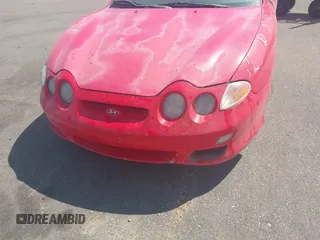 2001 Hyundai Tiburon z VIN KMHJG25F71U226180, wystawiony jako IAAI lot #42123872 z przebiegiem 167 444 mil mil oraz . Historia ofert i sprzedaży dostępna na DreamBid. Obrazek 6.