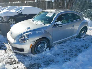 2012 Volkswagen Beetle 2.5L PZEV with VIN 3VWJP7AT4CM601556, listed as a IAAI auction lot 41240071 with 113,338 mi miles. Bid and sale history available at carsss.com. Image 2.