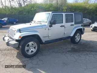 2009 Jeep Wrangler Unlimited Sahara with VIN 1J4GA59129L780013, listed as a IAAI auction lot 41976308 with 164,738 mi miles. Bid and sale history available at carsss.com. Image 2.