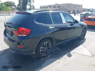 2015 BMW X1 sDrive28i with VIN WBAVM1C59FVW57928, listed as a IAAI auction lot 42056452 with 115,411 mi miles. Bid and sale history available at carsss.com. Image 4.