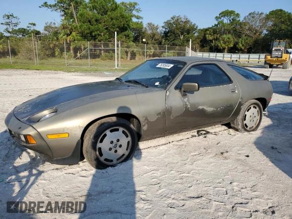 1984 Porsche 928 z VIN WP0JB0927ES862274, wystawiony jako Copart lot #75285934 z przebiegiem 97 509 mil mil oraz Czysty tytuł • Clean title. Historia ofert i sprzedaży dostępna na DreamBid. Obrazek 1.