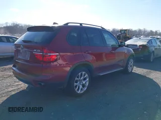 2011 BMW X5 35i with VIN 5UXZV4C52BL413125, listed as a IAAI auction lot 41697824 with 136,828 mi miles. Bid and sale history available at carsss.com. Image 4.