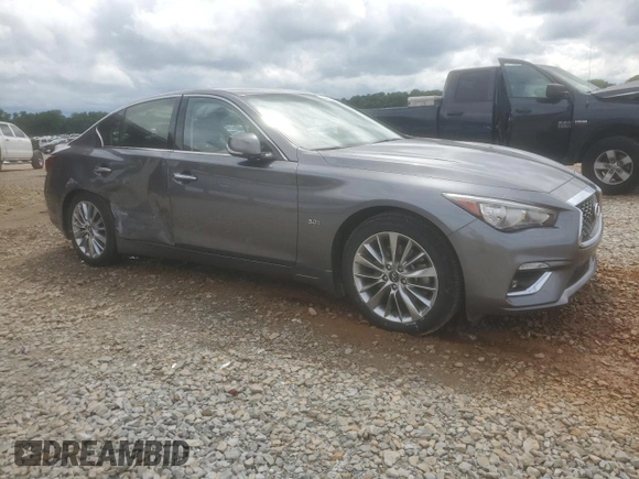 2019 Infiniti Q50 Luxe with VIN JN1EV7AP6KM517944, listed as a Copart auction lot 56942655 with 94,883 mi miles and Salvage title. Bid and sale history available at DreamBid. Image 4.
