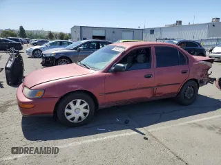 1997 Toyota Corolla with VIN 1NXBA02E3VZ591435, listed as a Copart auction lot 56938405 with 172,218 mi miles and Salvage title. Bid and sale history available at DreamBid. Image 1.