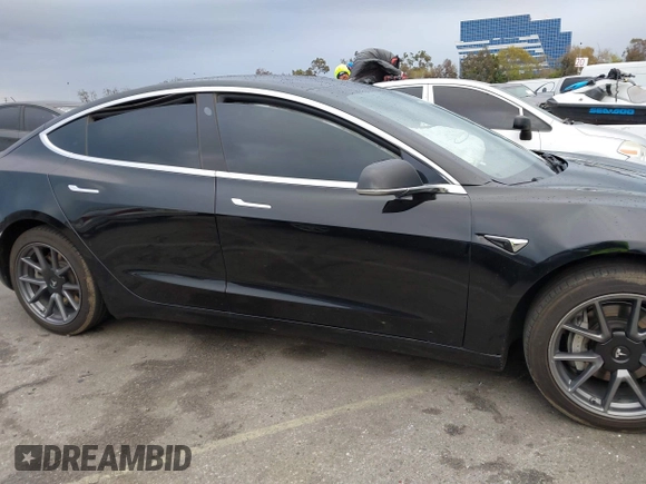 2019 Tesla Model 3 Mid Range with VIN 5YJ3E1EA6KF361808, listed as a IAAI auction lot 41767241 with 96,200 mi miles and . Bid and sale history available at carsss.com. Image 13.