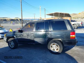 1998 Jeep Grand Cherokee Limited with VIN 1J4GX78Y8WC110325, listed as a IAAI auction lot 41357373 with 165,106 mi miles. Bid and sale history available at carsss.com. Image 14.