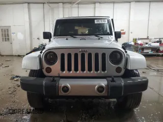 2009 Jeep Wrangler Sahara z VIN 1J4FA54189L789642, wystawiony jako Copart lot #89078145 z przebiegiem 128 902 mil mil oraz Szkoda całkowita • Salvage title. Historia ofert i sprzedaży dostępna na DreamBid. Obrazek 5.