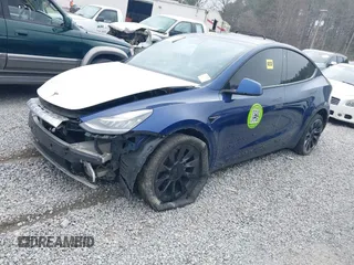 2021 Tesla Model Y Standard Range with VIN 5YJYGDED8MF122985, listed as a IAAI auction lot 41430423 with 120,302 mi miles and . Bid and sale history available at carsss.com. Image 2.