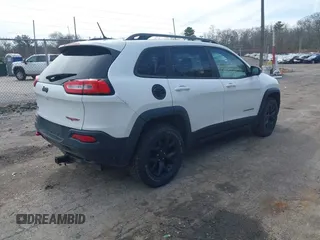 2014 Jeep Cherokee Trailhawk with VIN 1C4PJMBS5EW240375, listed as a IAAI auction lot 41806725 with 127,705 mi miles. Bid and sale history available at carsss.com. Image 4.