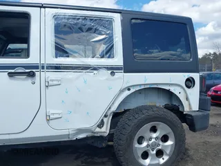 2015 Jeep Wrangler Unlimited Sahara with VIN 1C4HJWEG6FL556460, listed as a IAAI auction lot 42066648 with 54,747 mi miles. Bid and sale history available at carsss.com. Image 6.