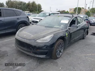 2019 Tesla Model 3 Mid Range with VIN 5YJ3E1EA2KF362048, listed as a IAAI auction lot 40141734 with 70,321 mi miles and . Bid and sale history available at carsss.com. Image 2.