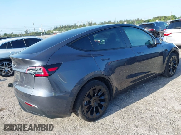 2023 Tesla Model Y Long Range z VIN 7SAYGDEE5PA099226, wystawiony jako IAAI lot #42004061 z przebiegiem 10 607 mil mil oraz . Historia ofert i sprzedaży dostępna na DreamBid. Obrazek 4.