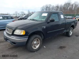 2000 Ford F-150 XL with VIN 1FTRX18WXYNC25817, listed as a IAAI auction lot 41976618 with 148,794 mi miles. Bid and sale history available at carsss.com. Image 2.