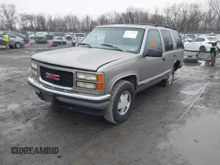 1999 GMC Yukon with VIN 1GKEK13R7XJ753243, listed as a IAAI auction lot 41231957 with 207,092 mi miles. Bid and sale history available at carsss.com. Image 2.