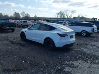 2023 Tesla Model Y Long Range with VIN 7SAYGDEE2PA059668, listed as a IAAI auction lot 41901079 with 58,276 mi miles. Bid and sale history available at carsss.com. Image 3.