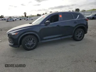 2020 Mazda CX-5 Touring z VIN JM3KFACM7L0720354, wystawiony jako Copart lot #53459805 z przebiegiem 59 490 mil mil oraz Szkoda całkowita • Salvage title. Historia ofert i sprzedaży dostępna na DreamBid. Obrazek 1.