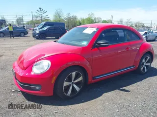 2012 Volkswagen Beetle 2.0T Turbo w/Sun/Snd/Nav PZEV with VIN 3VWVA7AT4CM608798, listed as a IAAI auction lot 42130353 with 152,052 mi miles. Bid and sale history available at carsss.com. Image 2.