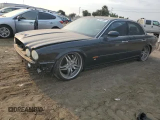 2004 Jaguar XJ with VIN SAJWA73B74TG18082, listed as a Copart auction lot 70516404 with 0 mi miles and Salvage Title. Bid and sale history available at carsss.com. Image 1.