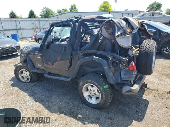 2002 Jeep Wrangler Sport with VIN 1J4FA49S02P721457, listed as a Copart auction lot 61726855 with 76,191 mi miles and Salvage title. Bid and sale history available at DreamBid. Image 2.