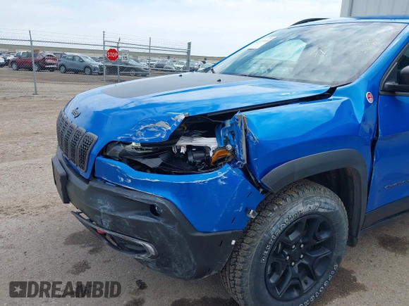 2022 Jeep Cherokee Trailhawk z VIN 1C4PJMBX4ND513488, wystawiony jako IAAI lot #42137114 z przebiegiem 12 306 mil mil oraz . Historia ofert i sprzedaży dostępna na DreamBid. Obrazek 6.