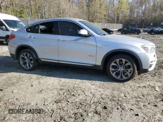 2017 BMW X4 xDrive28i with VIN 5UXXW3C52H0T77719, listed as a Copart auction lot 52393155 with 184,664 mi miles and Salvage title. Bid and sale history available at DreamBid. Image 4.