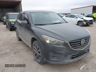 2016 Mazda CX-5 Grand Touring z VIN JM3KE2DY5G0651633, wystawiony jako IAAI lot #41588338 z przebiegiem 107 075 mil mil oraz . Historia ofert i sprzedaży dostępna na DreamBid. Obrazek 1.