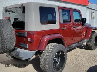 2010 Jeep Wrangler Unlimited Sahara with VIN 1J4BA5H10AL117474, listed as a IAAI auction lot 41969202 with 131,256 mi miles. Bid and sale history available at carsss.com. Image 4.